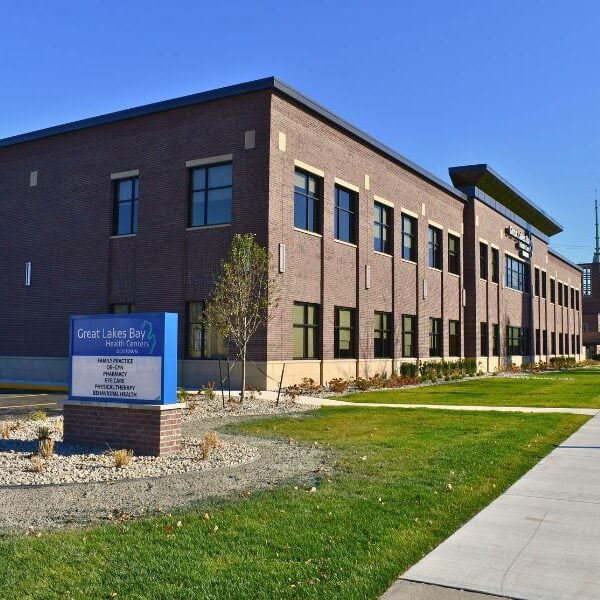 Exterior of Great Lakes Bay Health Centers Old Town. Masonry work done by Boettcher Masonry. Features their blue sign. Blue skies