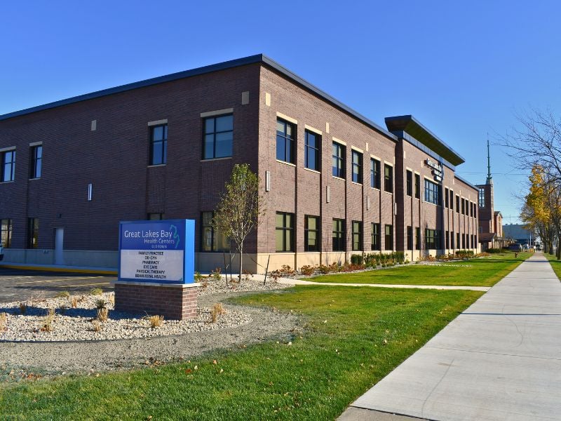 Exterior of Great Lakes Bay Health Centers Old Town. Masonry work done by Boettcher Masonry. Features their blue sign. Blue skies