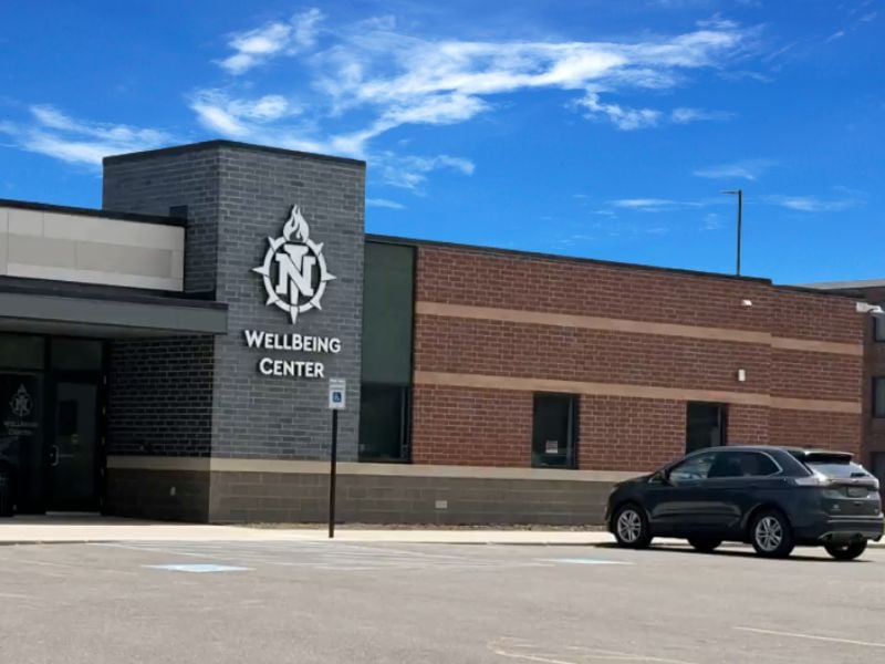 Exterior of NMU WellBeing Center featuring Boettcher Masonry’s craftsmanship with gray and brown brick design, showcasing a blend of textures and tones on Northern Michigan University’s campus.