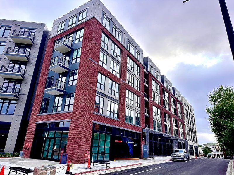 Exterior of 500 E. Main Street in North Carolina featuring 248 residential units, ground floor retail, and a structured parking garage. Showcase commercial masonry work.
