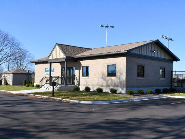 Exterior of Garber Tennis Courts building with courts in back.