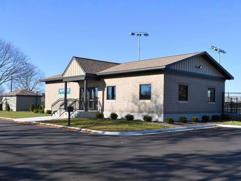 Exterior of Garber Tennis Courts building with courts in back.