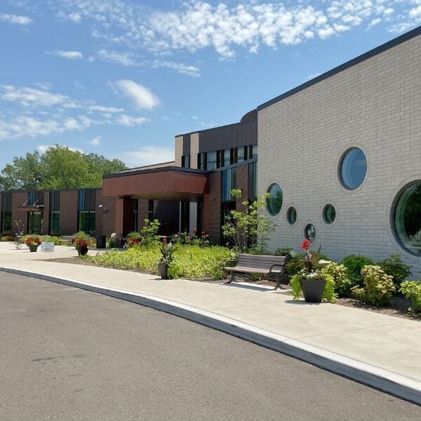 Greater Midland Community Center Main Walkway leading up to Greater Midland Community Center with Boettcher Masonry brick veneer, round windows, and landscaped surroundings.