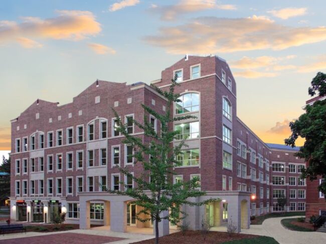 Exterior of Michigan State University Parking Deck #6 at evening sunset, featuring Boettcher Masonry’s classic brickwork with timeless design and historic campus charm.