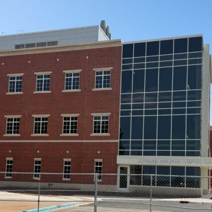 Entrance of Northern Michigan University’s Weston Hall featuring Boettcher Masonry’s detailed brickwork, tall windows, and building signage framed by walkways and parking lot.