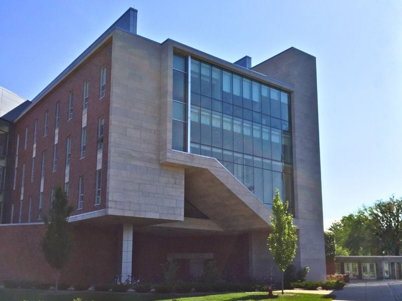 Exterior of Michigan State University’s Wells Hall expansion showcasing Boettcher Masonry’s craftsmanship with limestone from Capital Stoneworks and “Rustic Blend” brick from Sioux City Brick & Tile Company, combining warmth and texture in a modern vertical design.