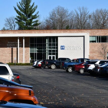 Wide view of Northwood University’s Richard DeVos Graduate School of Management from the parking lot, featuring Boettcher Masonry’s light and dark brick veneer over CMU.