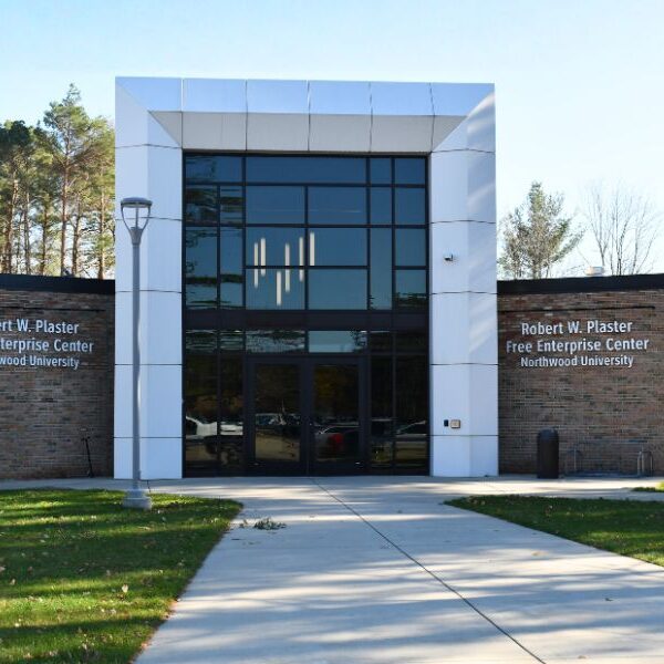 Exterior of Northwood University’s Robert W. Plaster Free Enterprise Center with Boettcher Masonry brick façade and large glass windows creating a modern academic design.