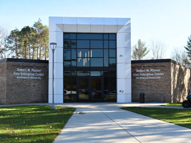 Exterior of Northwood University’s Robert W. Plaster Free Enterprise Center with Boettcher Masonry brick façade and large glass windows creating a modern academic design.