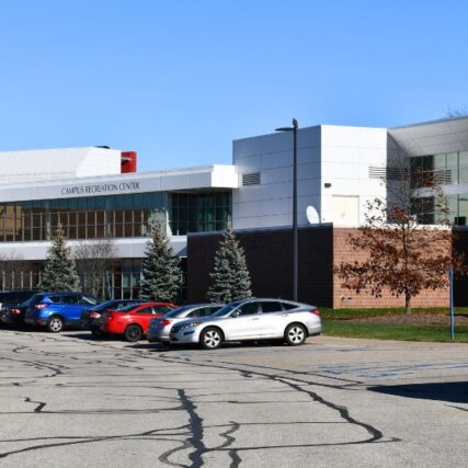 Parking lot view of Saginaw Valley State University’s Ryder Center Addition showcasing Boettcher Masonry’s light brick veneer and modern exterior design.